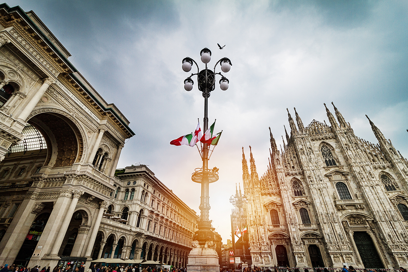 Panoramic view of Duomo square in Milan with big street lamp. Italy.